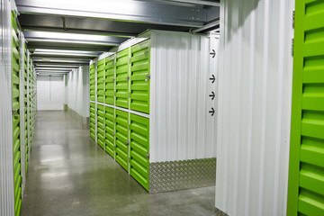 Image of empty warehouse with green chambers for boxes - obrazy, fototapety, plakaty