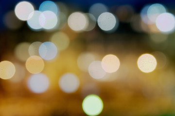 Abstract blurred background with copy space. Defocused night city with bokeh effect lanterns