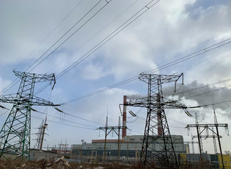 Smoke from industrial chimneys against a blue sky. Smoke from factory chimneys in an urban environment. Concept: environmental pollution.