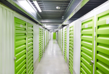 Image of green storage boxes for load in empty warehouse