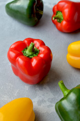Red fresh bell pepper with multi-colored sweet peppers. Green, red and yellow vegetables. Healthy food concept