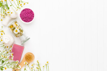 Spa still life with aromatherapy chamomile, herbal oil, soap, sea salt.