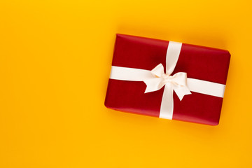Christmas, holiday present box on red background.