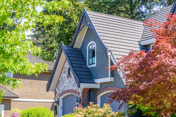 The top of the house or apartment building with nice window.
