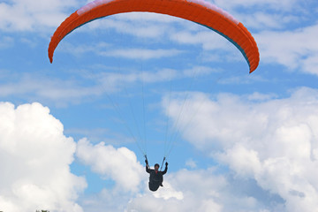 Paraglider flying wing in a blue sky	