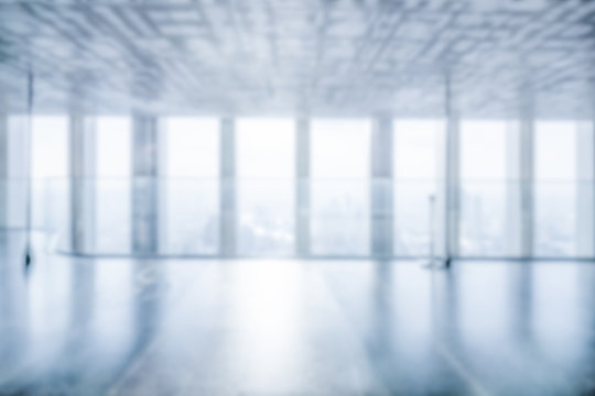 Blur background of empty office interior in city downtown. Modern workplace and conference hallway.