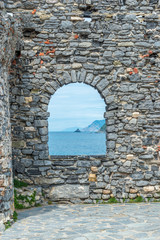 Ligurian coast. View from the old fortress arch in Portovenere town, Italy
