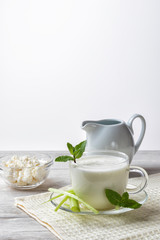 Pouring homemade kefir, yogurt with probiotics. Probiotic cold sour-milk drink. Fashionable food and drinks.