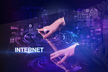 Businessman touching huge display with INTERNET inscription, modern technology concept