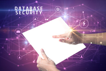 Holding futuristic tablet with DATABASE SECURITY inscription, cyber security concept