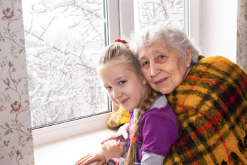 Happy beautiful great grandmother and her adorable granddaughter
