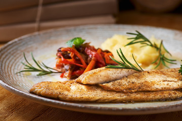 Fried fish with mashed potatoes and vegetable