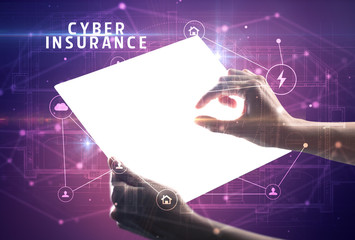 Holding futuristic tablet with CYBER INSURANCE inscription, cyber security concept