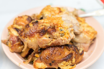 pieces of appetizing fried chicken close-up with a crispy crust lie on a plate