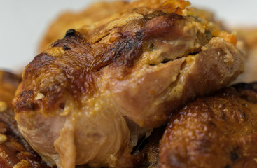 pieces of appetizing fried chicken close-up with a crispy crust lie on a plate