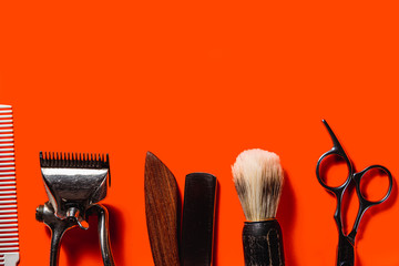 Old barber tools on an old beautiful Lush Lava surface. A razor, shaving brush, comb, hairdressers scissors, and a clipper. horizontal orientation. copy space