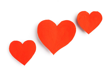 Cute red hearts lie on a white background.