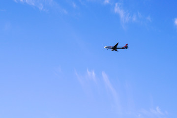 airplane in the blue sky small cloud