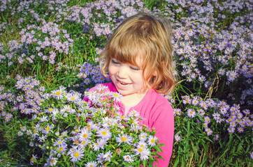 beautiful girl picking flowers for her mom