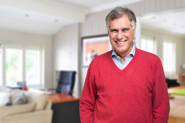 Smiling mature man at home in his living room
