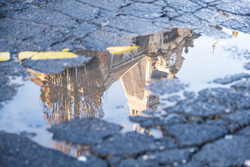 Architectural building reflection in a water puddle after the rain