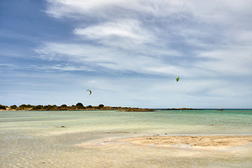 Kite surfing on Elafonissi beach on Crete island with azure clear water, Greece, Europe. Crete is the largest and most populous of the Greek islands.