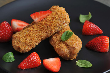 Choux pastry eclair with strawberries. A plate with a cake occupies the entire space of the frame. Close-up. Macro shot.