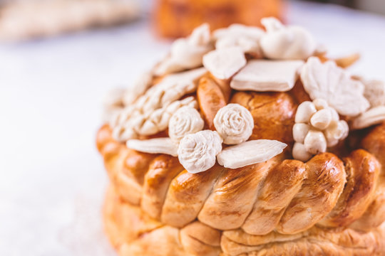 Close up of traditional holiday eastern Orthodox church bread with decoration on table.