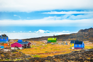 Colorful houses in Saqqaq village on the shore of Atlantic ocean, western Greenland. © smallredgirl