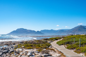Naklejka premium Hout Bay from a beach walkway in Kommitjie, Cape Town, south africa