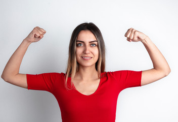 Young woman shows her strong arm. international women's day concept.