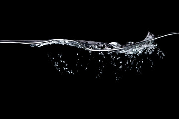 A wave of pure water with bubbles of water and air on a black background. - obrazy, fototapety, plakaty