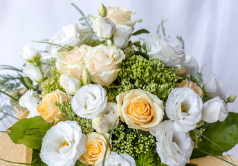 Fresh spring bouquet of rose and Eustoma flower in cream and white colors. Floral background