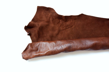 Leather in roll isolated on white background. Piece of brown leather isolated on white