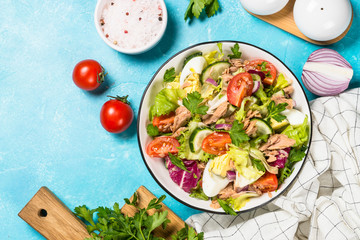 Tuna salad with green leaves, eggs and vegetables.
