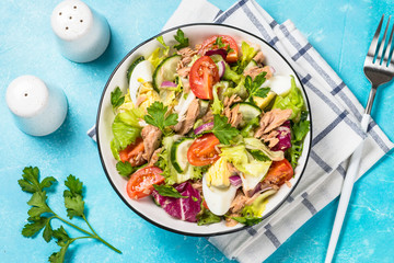 Tuna salad with green leaves, eggs and vegetables.