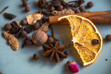 Dried oriental spices for making drinks on a home ceramic plate. Home kitchen.