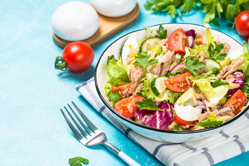 Tuna salad with green leaves, eggs and vegetables.
