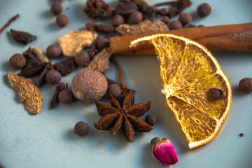 Dried oriental spices for making drinks on a home ceramic plate. Home kitchen.