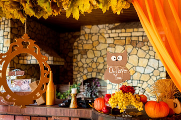 Beautiful autumn composition with pumpkins and leaves near wooden wall. Photozone.