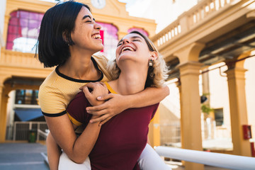 Loving lesbian couple having fun at the street.
