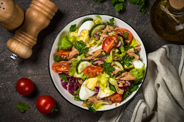 Tuna salad with green leaves, eggs and vegetables.