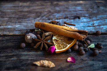 Dried oriental spices for the preparation of drinks on a wooden background.