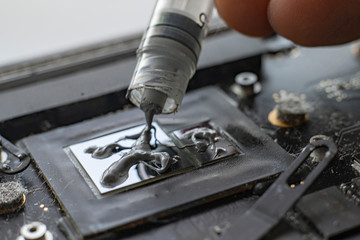 applying the thermal grease to the gpu chip for better heat management, macro view