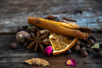 Dried oriental spices for the preparation of drinks on a wooden background.