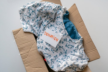 a carton box with clothes inside, a donation to children from poor countries