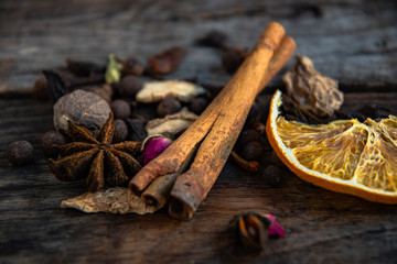 Dried oriental spices for the preparation of drinks on a wooden background.