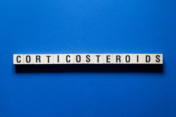 Corticosteroids word concept on cubes