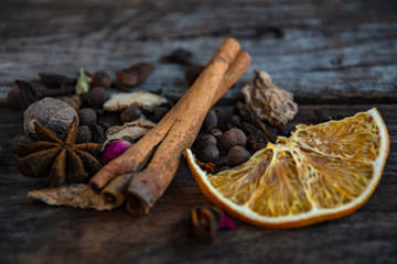 Dried oriental spices for the preparation of drinks on a wooden background.