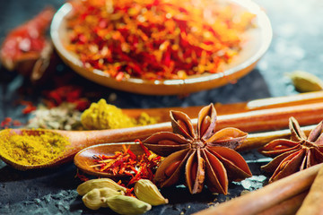 Spices. Various Indian Spices on black stone table. Spice and herbs on slate background. Assortment of Seasonings, condiments. Cooking ingredients, flavor